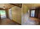 An unfinished room with plywood walls, plywood floor, a window, and two doors at 140 Dalu Ln, Harmony, NC 28634