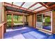 Comfortable covered back porch with a swing and space for enjoying the outdoors leading into the interior through glass doors at 141 Porter Rd, Statesville, NC 28625