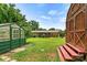 Beautiful backyard features a greenhouse, shed, and covered porch offering ample space for outdoor enjoyment at 141 Porter Rd, Statesville, NC 28625