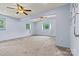 Spacious bedroom with carpeting, soft blue walls, and two windows providing natural light at 141 Porter Rd, Statesville, NC 28625
