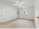 Bedroom featuring a carpeted floor, ceiling fan, and a window at 141 Porter Rd, Statesville, NC 28625