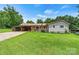Inviting single-story home featuring a well-manicured lawn and classic curb appeal at 141 Porter Rd, Statesville, NC 28625