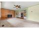 Spacious living room with a brick fireplace and a ceiling fan that opens to the kitchen and deck at 141 Porter Rd, Statesville, NC 28625