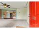 Bright living room with neutral carpet, a ceiling fan, and a brick accent wall at 141 Porter Rd, Statesville, NC 28625
