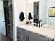 Bathroom with speckled quartz countertop vanity, modern fixtures and decorative mirror at 1543 Withers Dr, Denver, NC 28037
