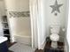 Bright bathroom with a tub, shower, toilet, vanity, and decorative star accent at 1543 Withers Dr, Denver, NC 28037