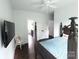 Bedroom featuring a four-poster bed, ceiling fan, TV, and a cozy chair at 1543 Withers Dr, Denver, NC 28037