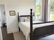 Cozy bedroom with a four-poster bed, accent pillows, and ample natural light at 1543 Withers Dr, Denver, NC 28037