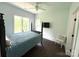 Bedroom featuring a four-poster bed, ceiling fan, TV, and a cozy chair at 1543 Withers Dr, Denver, NC 28037