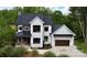 Beautiful modern farmhouse with black roof, white siding, and black trim, plus manicured landscaping at 1543 Withers Dr, Denver, NC 28037