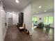 Hallway with wood flooring, open doorway to living area and staircase to the second floor at 1543 Withers Dr, Denver, NC 28037