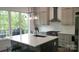 Modern kitchen featuring an island with barstool seating, white countertops, gray cabinets, and stainless appliances at 1543 Withers Dr, Denver, NC 28037
