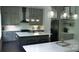 Modern kitchen with a large island, white countertops, gray cabinets, and pendant lighting above island at 1543 Withers Dr, Denver, NC 28037