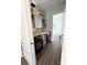 Well-organized laundry room featuring sleek, modern black washer and dryer beneath stylish gray cabinets at 1543 Withers Dr, Denver, NC 28037