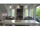 Bright living room with stone fireplace, comfortable sofas and large windows at 1543 Withers Dr, Denver, NC 28037