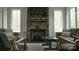 Inviting living room features a stone fireplace, large windows, and comfortable seating at 1543 Withers Dr, Denver, NC 28037