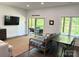 Living area features wood-look floors, a patio, and a TV for entertainment at 1543 Withers Dr, Denver, NC 28037