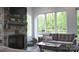 Cozy living room with stone fireplace, large windows and comfortable sofa at 1543 Withers Dr, Denver, NC 28037