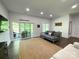 Cozy living area offers wood-look flooring, access to a patio, and ample natural light at 1543 Withers Dr, Denver, NC 28037