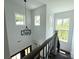 Open stairwell features a modern chandelier and large windows bringing in natural light at 1543 Withers Dr, Denver, NC 28037