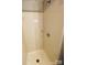 Bathroom shower with showerhead, soap holder, and tile walls at 1624 Arlyn Cir # G, Charlotte, NC 28213