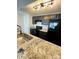 Modern kitchen featuring granite countertops, stainless steel sink, and black appliances at 1624 Arlyn Cir # G, Charlotte, NC 28213