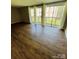 Open living area with sliding glass doors to the deck and laminate flooring at 1624 Arlyn Cir # G, Charlotte, NC 28213