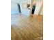 Spacious living room with wood-look laminate flooring and connecting kitchen at 1624 Arlyn Cir # G, Charlotte, NC 28213