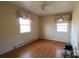 Neutral bedroom featuring hardwood floors, two windows with valances, and ceiling fan at 170 Heritage Ln, Salisbury, NC 28147