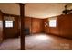 Traditional living room features a red brick fireplace, wood paneling, and ceiling fan at 170 Heritage Ln, Salisbury, NC 28147