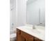 Bathroom with wood vanity, large mirror, and tub shower at 17119 Doe Valley Ct, Cornelius, NC 28031