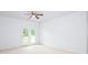 Bright bedroom with a ceiling fan and French doors leading to a balcony at 17119 Doe Valley Ct, Cornelius, NC 28031