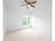 Bright bedroom with light walls, a ceiling fan and window at 17119 Doe Valley Ct, Cornelius, NC 28031