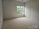 Bright bedroom featuring a window view and a large closet at 17119 Doe Valley Ct, Cornelius, NC 28031