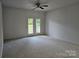 Bedroom with French doors that open to a private balcony overlooking wooded yard at 17119 Doe Valley Ct, Cornelius, NC 28031