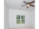 Bright bedroom with ceiling fan and large windows with a view of lawn at 17119 Doe Valley Ct, Cornelius, NC 28031