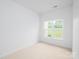 Empty room with carpeted floors and bright windows at 17119 Doe Valley Ct, Cornelius, NC 28031