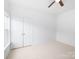 Bedroom with light walls, a ceiling fan and double door closet at 17119 Doe Valley Ct, Cornelius, NC 28031