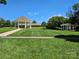 Beautiful community gazebo and picnic area with lush green lawn under a clear blue sky at 17119 Doe Valley Ct, Cornelius, NC 28031