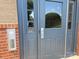 Close-up of the front door with a secure, modern electronic entry system and a brick facade at 17119 Doe Valley Ct, Cornelius, NC 28031