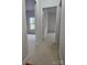 Neutral hallway with carpet, white walls, and white doors leads to bedrooms at 17119 Doe Valley Ct, Cornelius, NC 28031