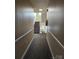 A narrow hallway with a carpet runner leading to stairs with natural light and a fire extinguisher at 17119 Doe Valley Ct, Cornelius, NC 28031