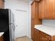 Bright kitchen features stainless steel refrigerator, and wood cabinets at 17119 Doe Valley Ct, Cornelius, NC 28031
