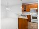 Bright kitchen showcasing wood cabinets, essential appliances, and an open space at 17119 Doe Valley Ct, Cornelius, NC 28031