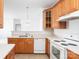 Bright kitchen features wood cabinets, essential appliances, and stylish lighting at 17119 Doe Valley Ct, Cornelius, NC 28031