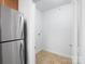 Bright laundry room with a stainless steel refrigerator and neutral walls at 17119 Doe Valley Ct, Cornelius, NC 28031