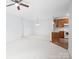 Inviting living room showcasing a kitchen, neutral walls and a ceiling fan at 17119 Doe Valley Ct, Cornelius, NC 28031