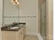 Bathroom featuring double sink vanity with granite countertops and a glass-door shower at 17210 Sulky Plough Rd # 1206, Charlotte, NC 28277