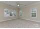 A bright bedroom featuring neutral walls, carpet, recessed lighting, and large windows at 17210 Sulky Plough Rd # 1206, Charlotte, NC 28277