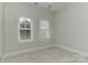 Bright bedroom with neutral walls, carpet, a ceiling fan, and two windows at 17210 Sulky Plough Rd # 1206, Charlotte, NC 28277